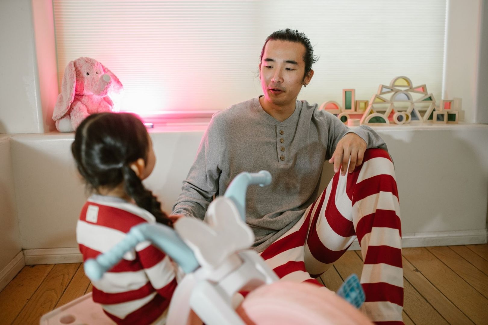 Father and daughter spend time together on the floor at home